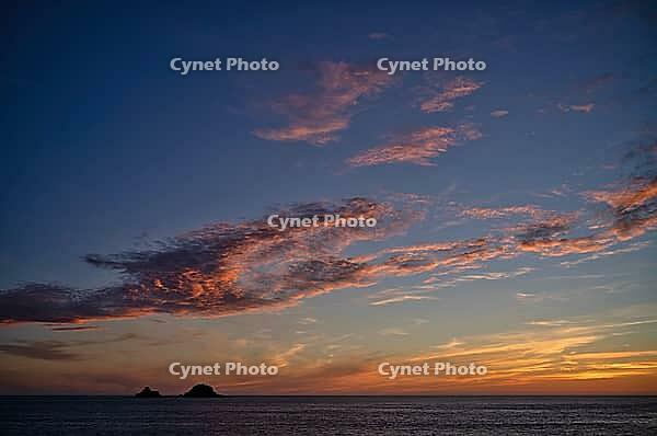 Sunset, sunset at sea, dramatic clouds, in the background rock formation The Brisons, Cot Valley Beach, Porth Nanven, coast, St Just in Penwith, Cornwall, England, Great Britain, Great Britain [IBR125177970]