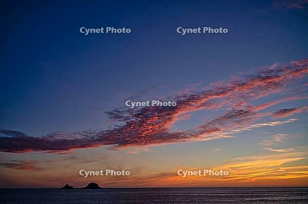 Sunset, sunset at sea, dramatic clouds, in the background rock formation The Brisons, Cot Valley Beach, Porth Nanven, coast, St Just in Penwith, Cornwall, England, Great Britain, Great Britain [IBR125177971]