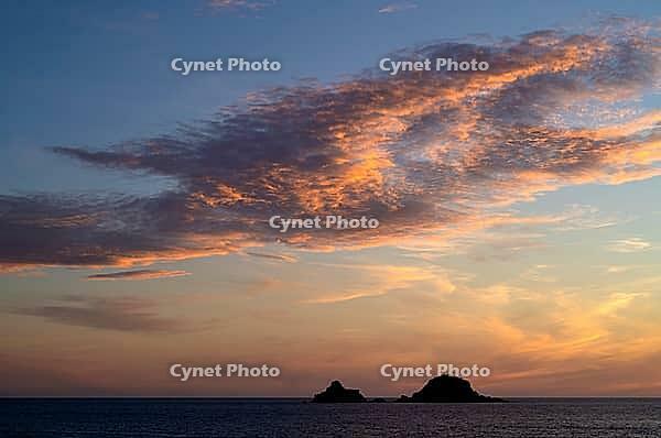 Sunset, sunset at sea, dramatic clouds, in the background rock formation The Brisons, Cot Valley Beach, Porth Nanven, coast, St Just in Penwith, Cornwall, England, Great Britain, Great Britain [IBR125177995]
