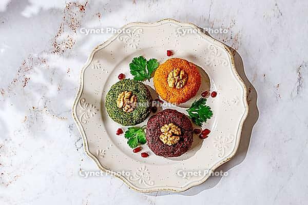 Assortment of Phali, three types, pumpkin, spinach and beetroot, on a round plate, Georgian dish, appetizer with nuts and spices, no people, homemade [IBR125178022]