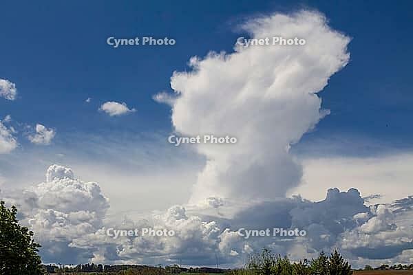 Dramatic cloud formation with impending storm clouds against a still blue sky [IBR125180322]