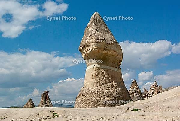 Scenic Cappadocia valley in Turkey featuring fairy chimneys, soft sunlight, rugged formations, and greenery in Turkey [IBR125180367]