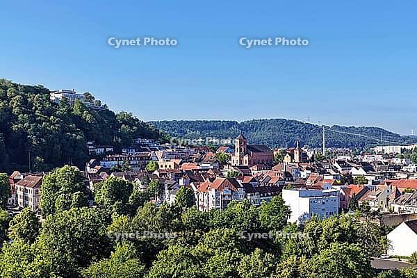 Elevated view of the historic old town of Homburg. In the center, the Lutheran Town Church stands out with its reddish masonry. The left side of the picture is dominated by the densely wooded Schlossberg, on whose top the Schlossberghotel is visible. A se [IBR125180383]
