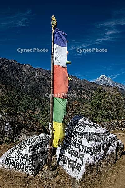 Buddhist prayer flag and holy mantras on manistones on the way to Mount Everest, Solu Khumbu, Himalayas, Nepal [IBR113313522]