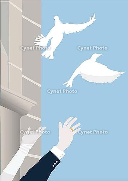 Two white doves soar into the sky in front of an old church. The hands of the bride and groom wave after the doves. A symbol of wedding, love, good luck and a lucky charm [IBR125185828]