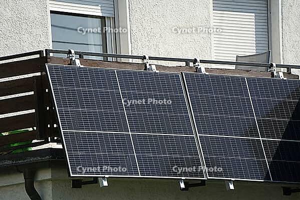 A large balcony power plant is mounted on the balcony cladding. The Sun is Shining on the Solar Modules That Are Mounted at an Angle [IBR125185842]