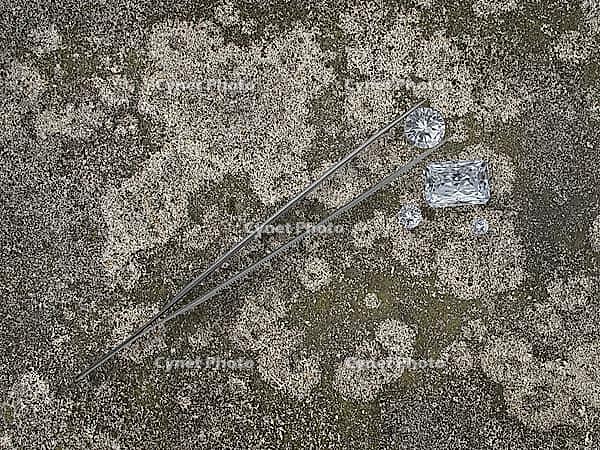 Various cut cluster of diamonds on an old cement [IBR125188171]