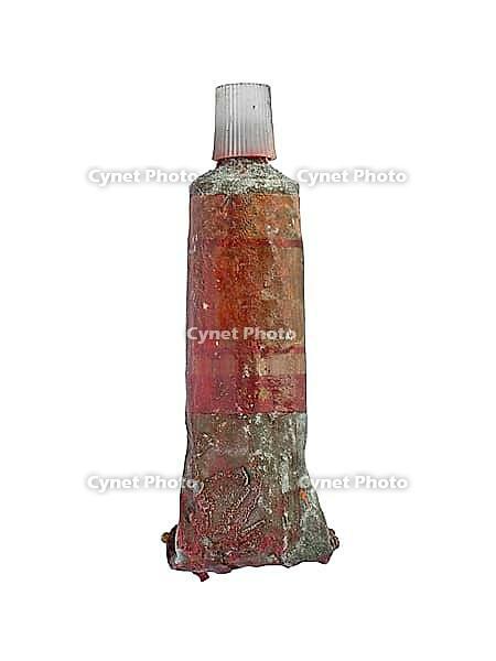 Vintage used red oil paint tube over white, clipping path [IBR125188187]