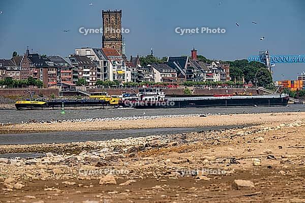 Rhine near Emmerich, extreme low water, Rhine level at 5 cm, downward trend, cargo ships sometimes only have to travel with 30 percent of the usual load, backdrop of the Emmerich waterfront, North Rhine-Westphalia, Germany [IBR113322459]