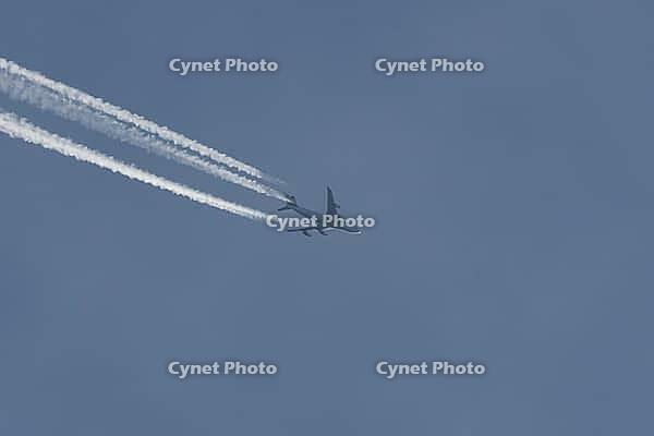 Boeing 747 jumbo jet cargo aircraft of Magma airlines flying in a blue sky with contrails or vapour trails behind in the atmosphere, England, United Kingdom [IBR125204160]