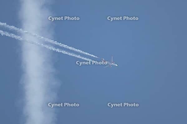 Airbus jet passenger aircraft of Easyjet airlines flying in a blue sky with contrails or vapour trails behind in the atmosphere, England, United Kingdom [IBR125204171]