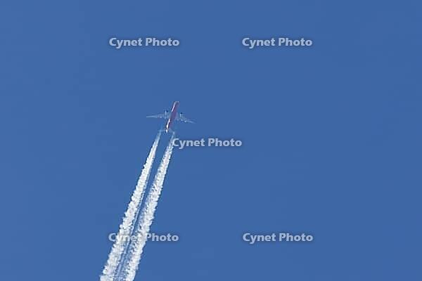 Airbus jet cargo aircraft of DHL airlines flying in a blue sky with contrails or vapour trails in the atmosphere, England, United Kingdom [IBR125204175]
