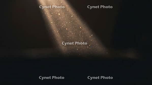 Extreme close-up of a light beam with suspended particulate matter glowing against a dark surround, indoor smoke contamination visualization, AI generated [IBR125211548]