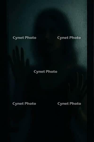 A silhouette of a woman with hands on glass, casting a mysterious shadow, AI generated [IBR125211553]