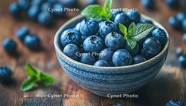 Fresh Blueberries In A Rustic Wooden Bowl: Delicious And Nutritious Organic Seasonal Fruit With Mint Leaf On A Close-Up Shot, AI generated [IBR125229872]