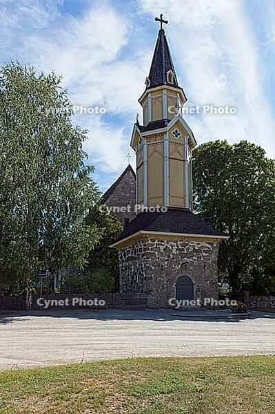 Wooden bell tower of old stone Pertteli church in summer with clouds in the sky, Pertteli, Finland [IBR125242406]