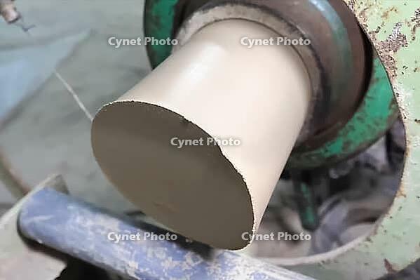 Pressing of clay mortar to prepare it for commercial, condition, and subsequent transportation [IBR125242439]