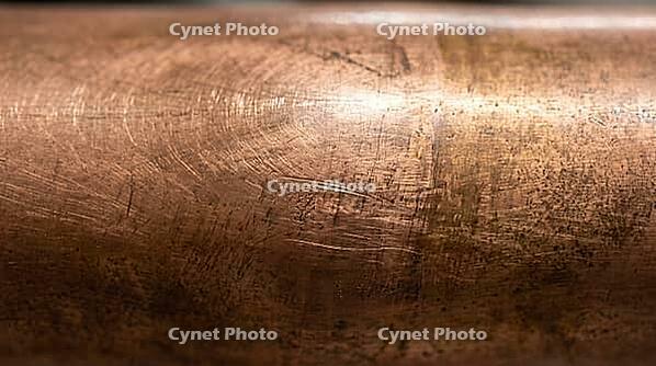 Extreme macro of a copper pipe with an almost imperceptible bulge, physical evidence of repeated water hammer pressure shock, studio shot, AI generated [IBR125242472]