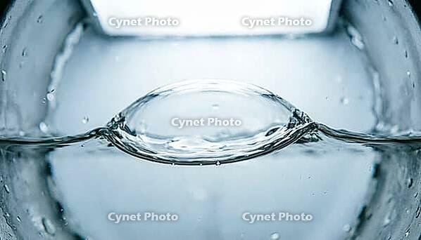 Abstract macro of an air pocket compressing against water inside a water hammer arrestor chamber, pressure cushioning mechanism, studio shot, AI generated [IBR125242474]