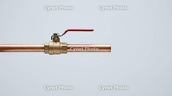 Ordinary copper pipe with a closed shutoff valve, calm exterior hiding the violent pressure transient of water hammer, studio shot, AI generated [IBR125242479]