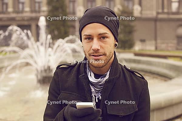 Traveling Man With Mobile Phone And Hat In City, Urban Space [IBR125261558]
