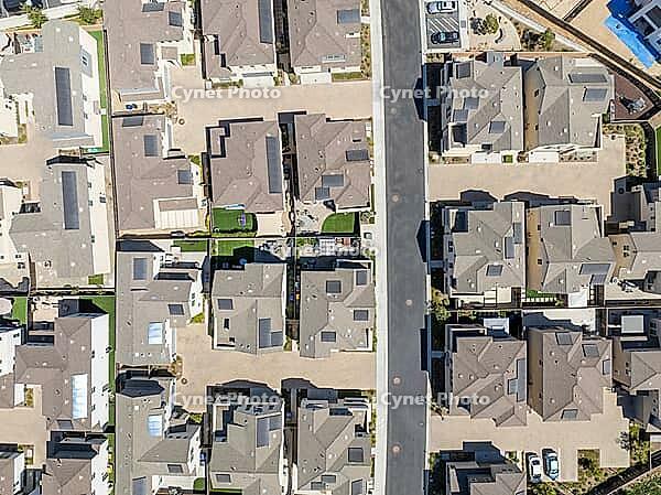 New development real estate. Aerial view of residential houses and driveways neighborhood in south San Diego, Chula Vista. Packed homes. Top view over private houses [IBR125280296]