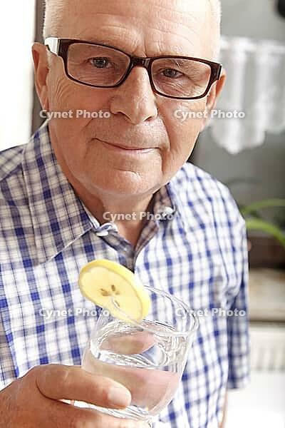 Senior with water glass [IBR125280307]