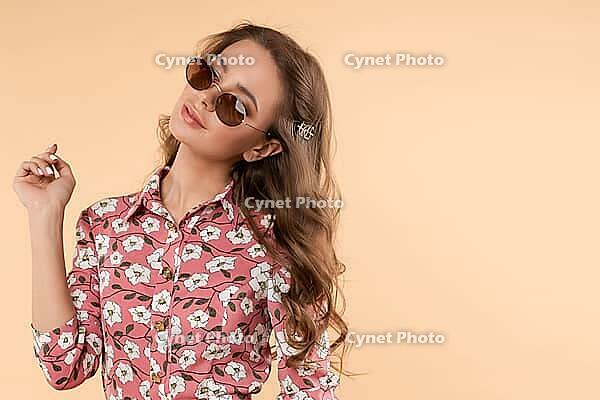 Front view of stylish girl wearing white light dress looking at camera and posing on isolated background. Pretty young woman with makeup and hairstyle enjoying new outfit. Concept of fashion [IBR125280310]
