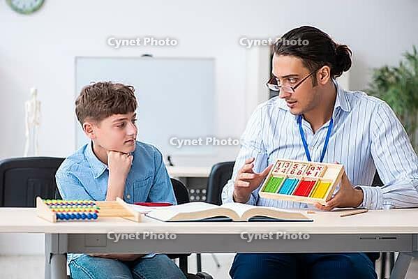 The young father helps his son prepare for the exam [IBR125304601]
