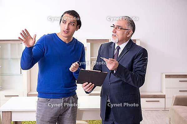 The male real estate agent and the male client in the apartment [IBR125304605]