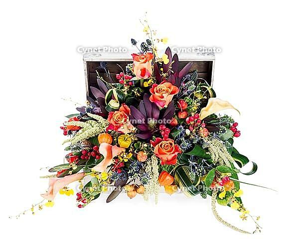 A colorful floral arrangement of roses, lilies, freesia and irises in a wooden chest, isolated on white background [IBR125304622]