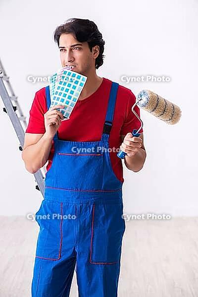 Young handsome contractor working indoors [IBR125304635]