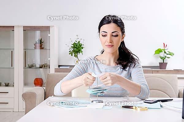 The young woman in a budget planning concept [IBR125304638]