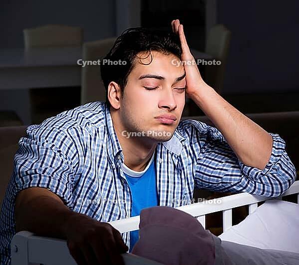 The young father who sleeps while taking care of a newborn baby [IBR125304643]