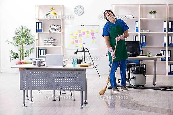 Male handsome professional cleaner working in office [IBR125304649]