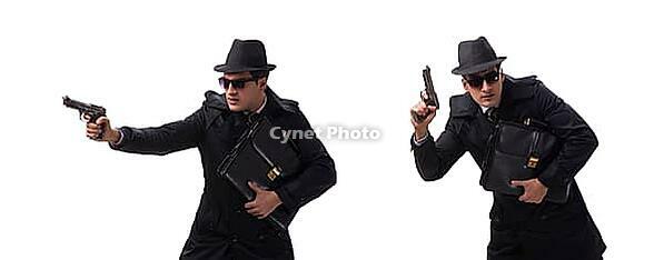 Spy man with pistol against white background [IBR125304657]