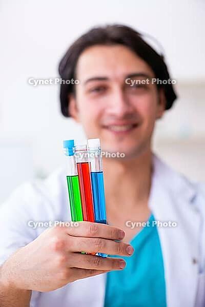 Young male chemist working in laboratory [IBR125304677]