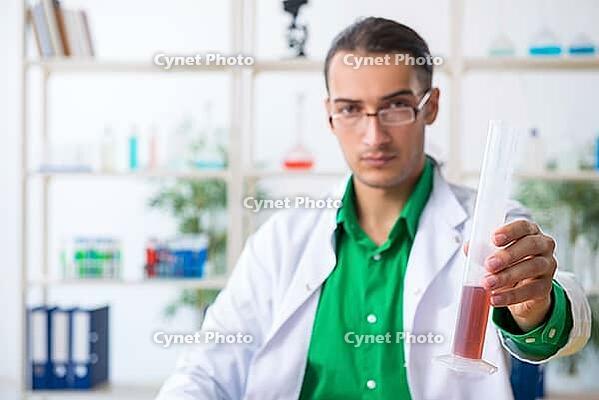 The young male chemistry teacher in the laboratory [IBR125304684]