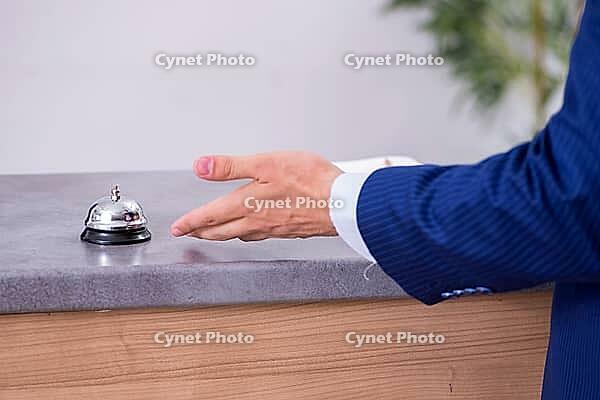 Young businessman at hotel reception [IBR125324058]