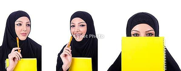 Young muslim woman with book on white [IBR125324076]