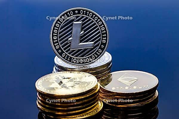 A single litecoin coin on top of a pile of crypto currency [IBR125324138]