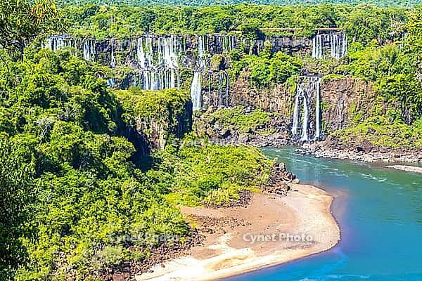Foz do Iguacu Iguazu Falls waterfall fall waterfalls cascade cascades in tropical nature rainforest panorama view with blue sky and turquoise green water in Parana Brazil and Misiones Argentina [IBR125324144]