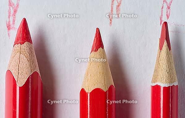 A row of wooden red pencils with sharp tips for drawing on a white background [IBR125331121]