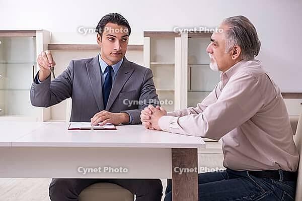 Male real estate agent and male client in the apartment [IBR125331132]