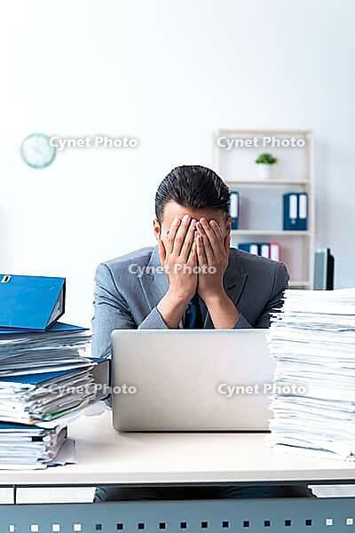 The businessman with lots of paperwork [IBR125331148]