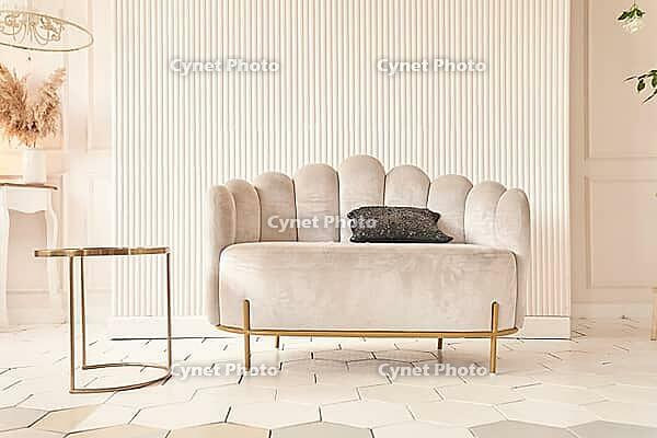 Creative composition of the living room interior with an uneven sofa in a modern style, a pot with a plant. Home decor. Pattern. [IBR125331153]