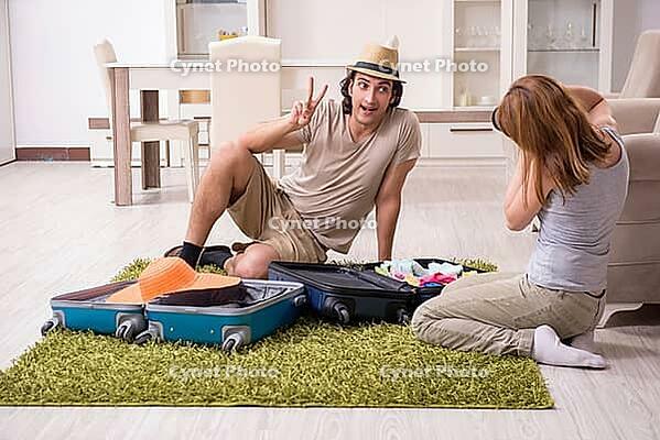 The young couple is preparing for the trip [IBR125331188]