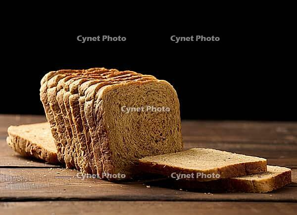 Sliced wheat flour bread on a wooden board. Sandwich bread [IBR125331200]