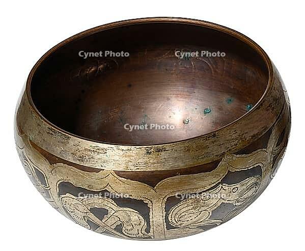 Copper singing bowl for meditation and relaxation on isolated background [IBR125344242]