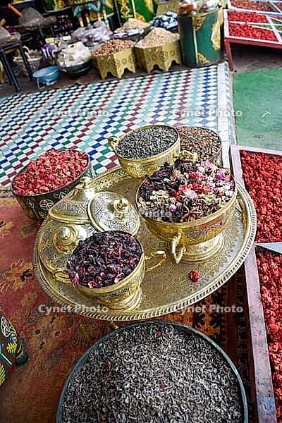 Golden bowls at street stalls in Marrakech with different spices, teas and incense. Morocco [IBR125344250]